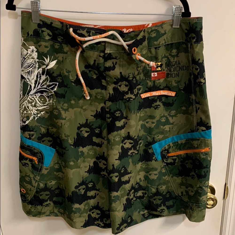 Live Mechanics Green/Blue Board Shorts with Drawstring Waist Camo Lion design.